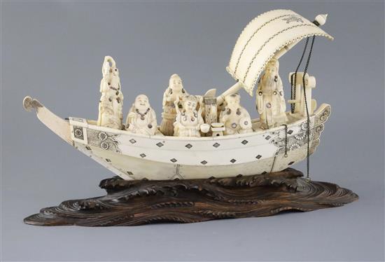 A large Japanese sectional ivory and whale tooth model of the Takarabune, Meiji period, L. 36.5cm, on a wood stand carved as waves